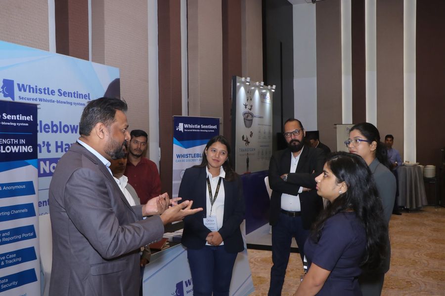 The WhistleSentinel team in discussion with summit attendees